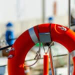 orange lifebuoy attached to boat