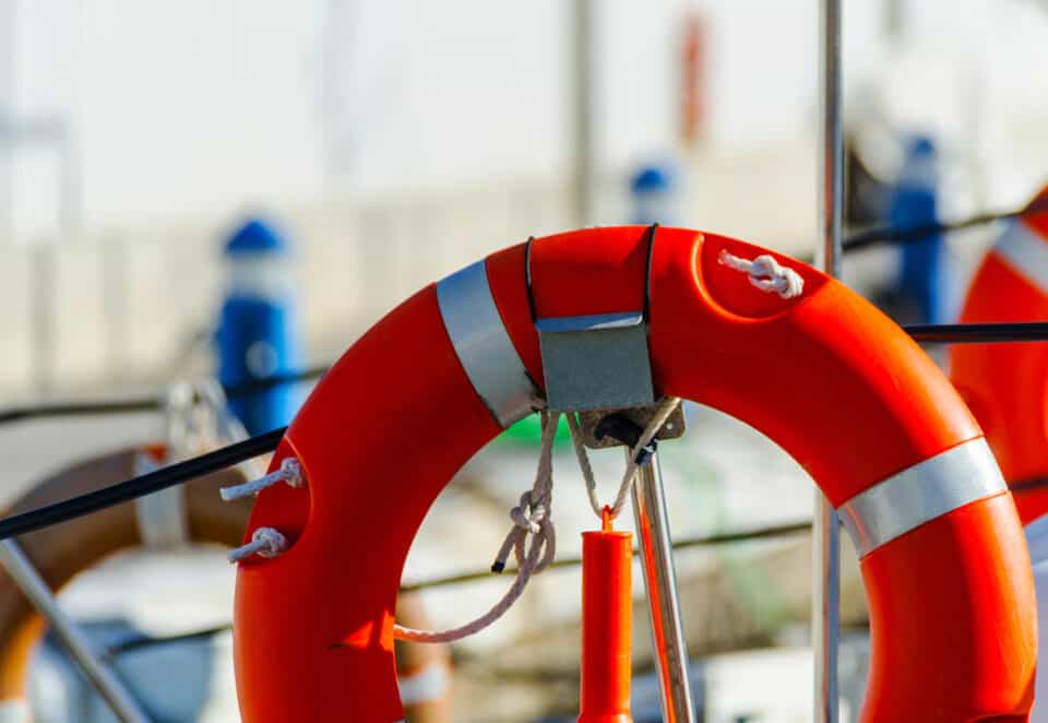 orange lifebuoy attached to boat
