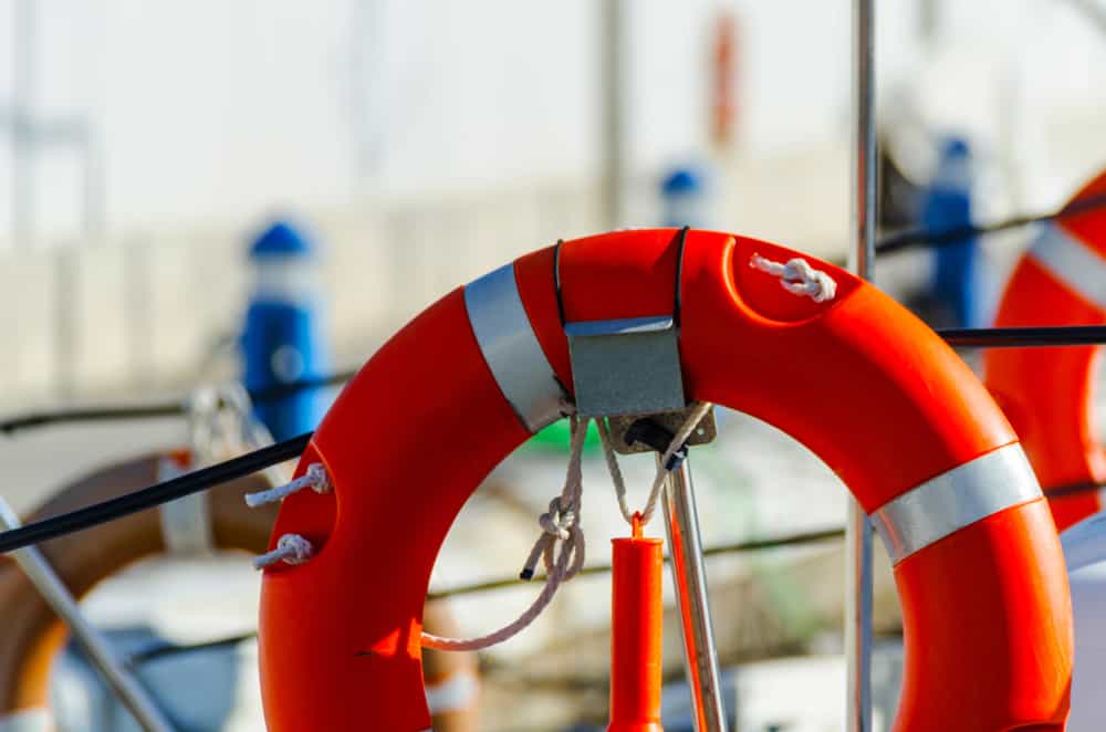 orange lifebuoy attached to boat